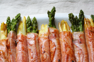 Gebratener weisser und grüner Spargel mit Schinken ummantelt, Nahaufnahme