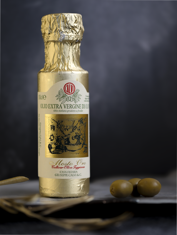 Product Photography - Exklusives Olivenöl in goldener Folie vor dunklem Hintergrund